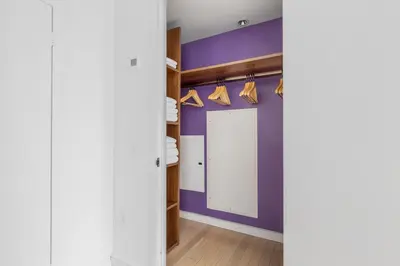 a dressing room with purple walls and a closet at Midtown 1br w doorman gym wd nr Rock Center NYC-1127 in New York