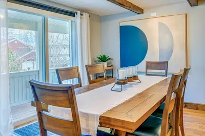 a dining room with a wooden table and chairs at Saratoga Springs Vacation Rental with Lake Views! in Saratoga Springs