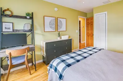 a bedroom with a bed and a desk and a tv at Saratoga Springs Vacation Rental with Lake Views! in Saratoga Springs