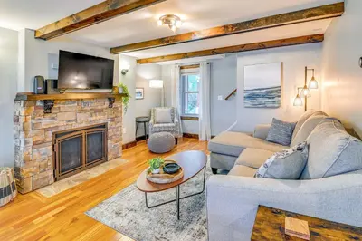 a living room with a couch and a fireplace at Saratoga Springs Vacation Rental with Lake Views! in Saratoga Springs