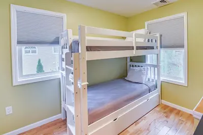 a bunk bed room with two bunk beds and two windows at Saratoga Springs Vacation Rental with Lake Views! in Saratoga Springs
