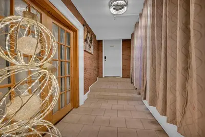 a hallway with a stairway with a glass door at Beacon Hotel in Beacon