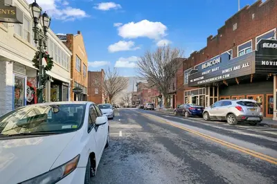 a white car parked on the side of a city street at Beacon Hotel in Beacon