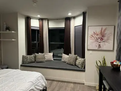 a window seat in a bedroom with a bed and pillows at Beacon Hotel in Beacon