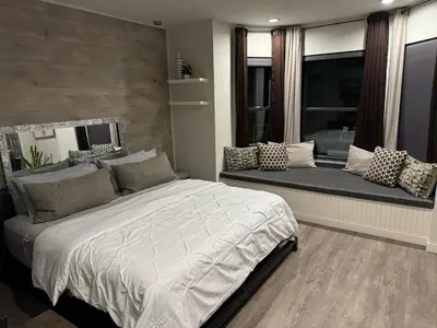 a bedroom with a large bed and a window seat at Beacon Hotel in Beacon