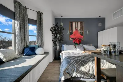 a bedroom with a bed and a large window at Beacon Hotel in Beacon