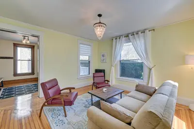 a living room with a couch and a table and chairs at Spacious Historic Home in the Berkshires! in Pittsfield
