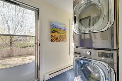 a washer and dryer in a room with a window at Spacious Historic Home in the Berkshires! in Pittsfield