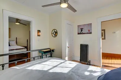 a bedroom with a bed and a mirror at Spacious Historic Home in the Berkshires! in Pittsfield