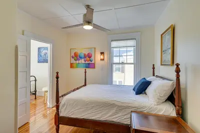 a bedroom with a bed with a wooden floor at Spacious Historic Home in the Berkshires! in Pittsfield