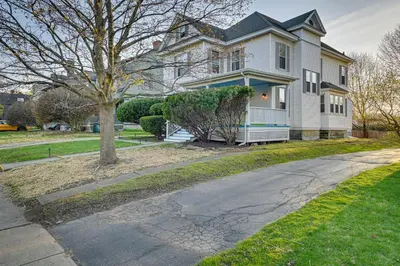 a white house with a tree and a driveway at Spacious Historic Home in the Berkshires! in Pittsfield