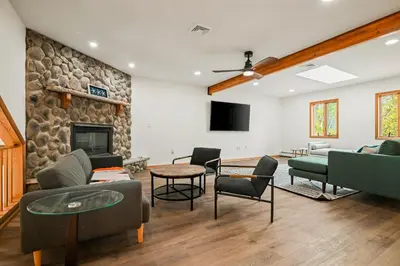 a living room with couches and a stone wall at 226 E Shore Dr in East Stroudsburg
