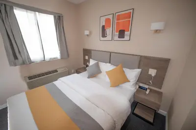 a bedroom with a large bed and a window at Flushing Garden Hotel in Queens