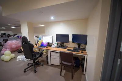 an office with a desk with two monitors and two chairs at Flushing Garden Hotel in Queens