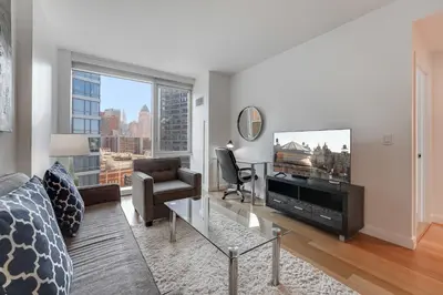 a living room with a couch and a tv at Global Luxury Suites at Via 57 in New York