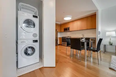 a kitchen and living room with a washer and dryer at Global Luxury Suites at Via 57 in New York