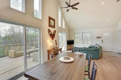 a dining room and living room with a wooden table at Sleepy Hollow Lake Home with Deck, Pool Access! in Athens