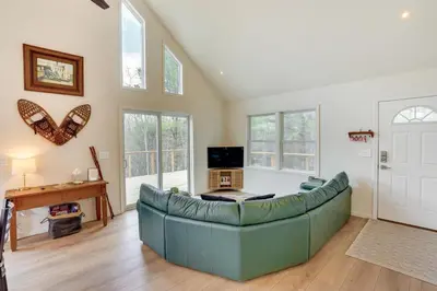 a living room with a couch and a tv at Sleepy Hollow Lake Home with Deck, Pool Access! in Athens