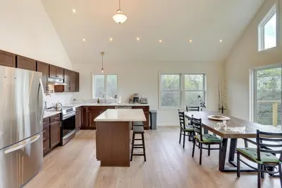 a kitchen with a refrigerator and a table with chairs at Sleepy Hollow Lake Home with Deck, Pool Access! in Athens