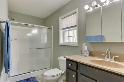 a bathroom with a shower and a toilet and a sink at Walk to Lake Wallenpaupack Poconos Vacation Home in Lake Ariel
