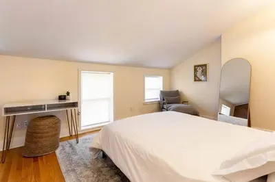 a bedroom with a bed and a desk and a chair at The Brick House at Yale New Haven ( Wooster Square) in New Haven