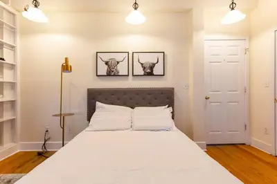 a bedroom with a bed with two skulls on the wall at The Brick House at Yale New Haven ( Wooster Square) in New Haven