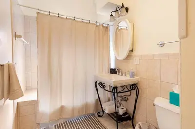a bathroom with a sink and a shower curtain at The Brick House at Yale New Haven ( Wooster Square) in New Haven