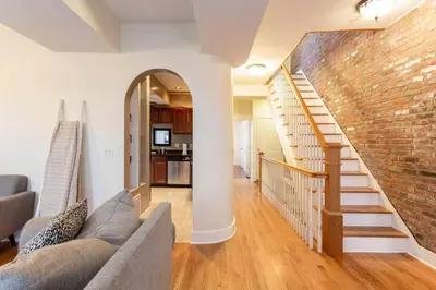 a living room with a couch and a brick wall at The Brick House at Yale New Haven ( Wooster Square) in New Haven