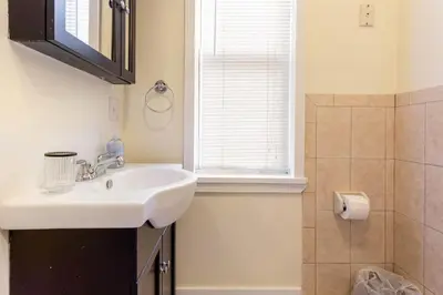 a bathroom with a sink and a window at The Brick House at Yale New Haven ( Wooster Square) in New Haven