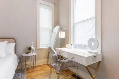 a bedroom with a dressing table and a mirror at The Matisse at Wooster Square Yale With Parking in New Haven