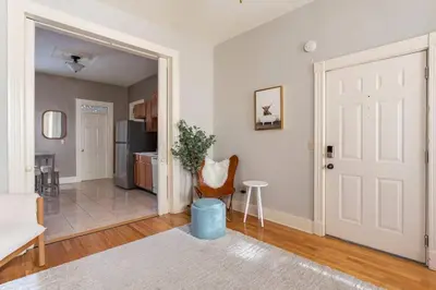 a living room with a door leading to a kitchen at The Matisse at Wooster Square Yale With Parking in New Haven